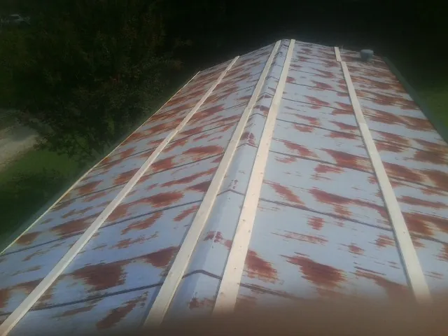 Rusted metal roof panels with new wood purlins before replacement — Storm Damage Roof Repair in Greenbush by Roofing Brothers